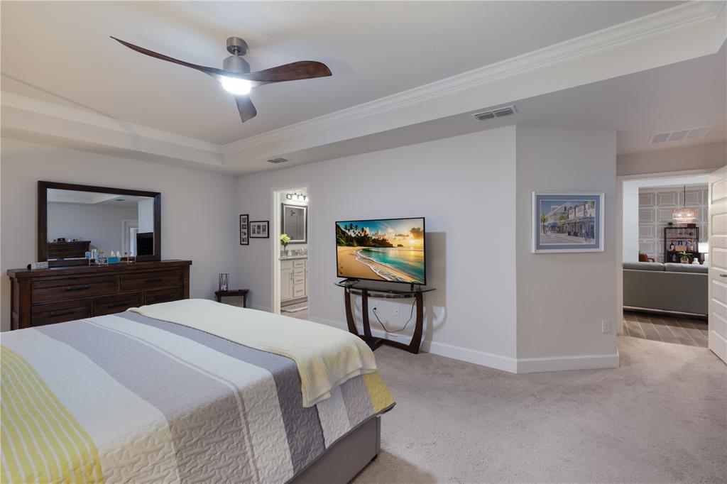 9318 46th Court East Parrish, FL 34219 - Photo 15 of 35 a bedroom with a bed and a chandelier