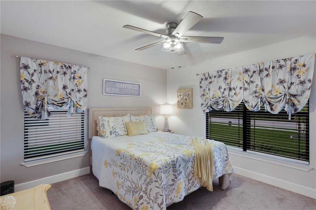 9318 46th Court East Parrish, FL 34219 - Photo 19 of 35 a bedroom with a bed and a chandelier