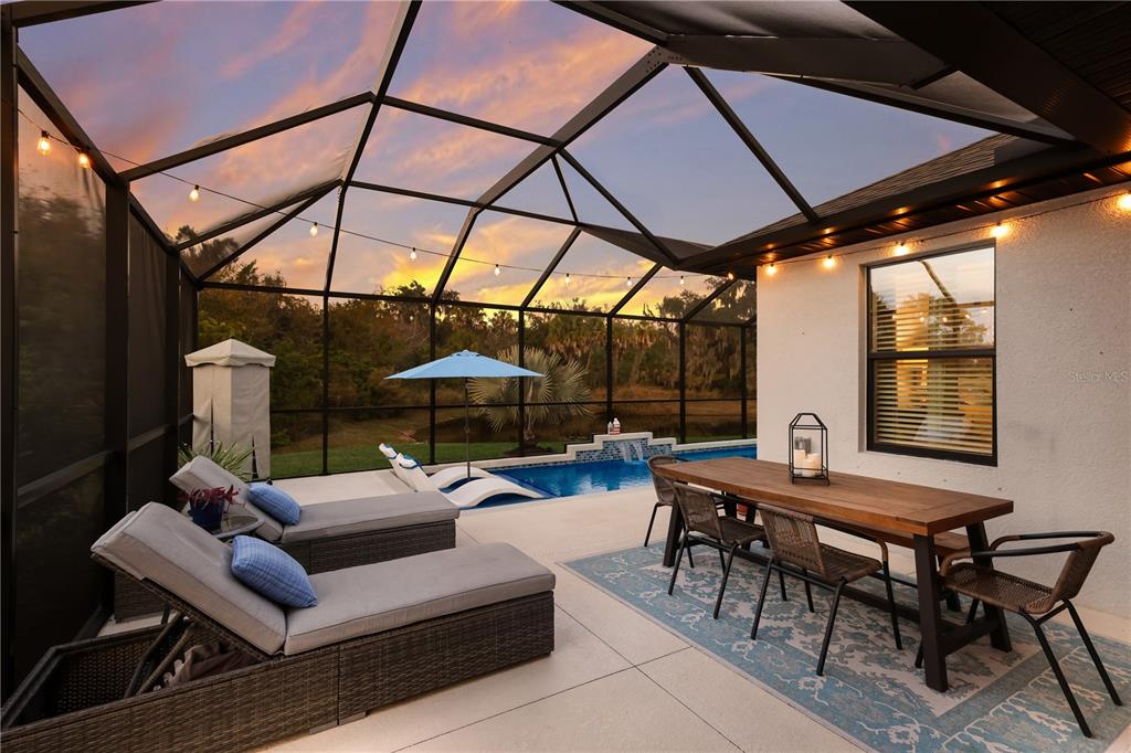 9318 46th Court East Parrish, FL 34219 - Photo 26 of 35 a view of a patio with a dining table and chairs