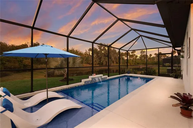 a view of a backyard with swimming pool