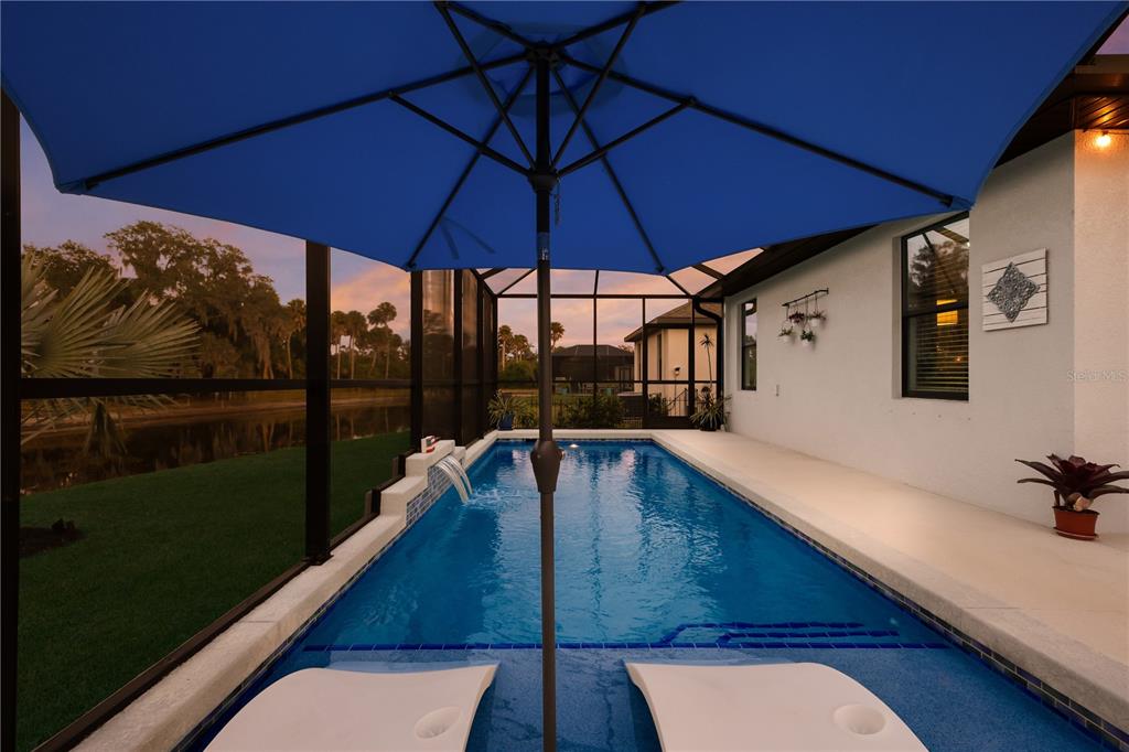 9318 46th Court East Parrish, FL 34219 - Photo 28 of 35 a view of a balcony with chairs and an umbrella