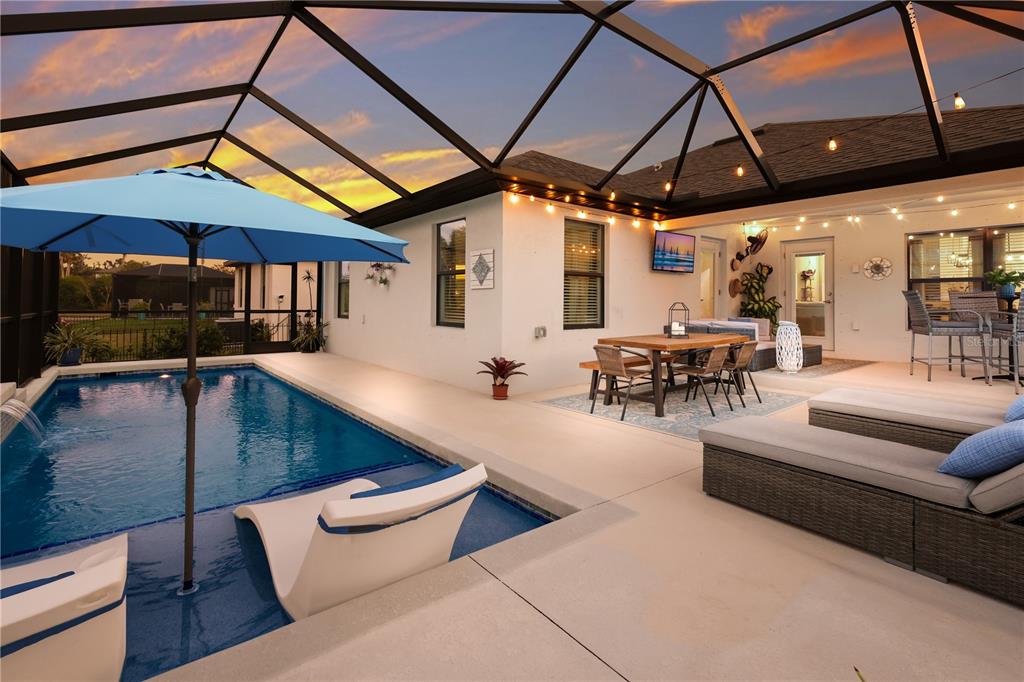 9318 46th Court East Parrish, FL 34219 - Photo 29 of 35 a outdoor space with patio lots of furniture and umbrella