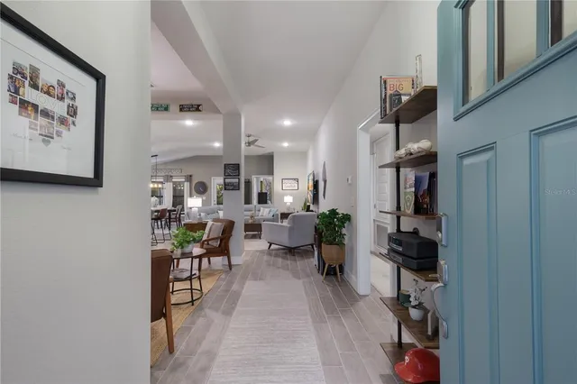 a living room with furniture a rug and white walls