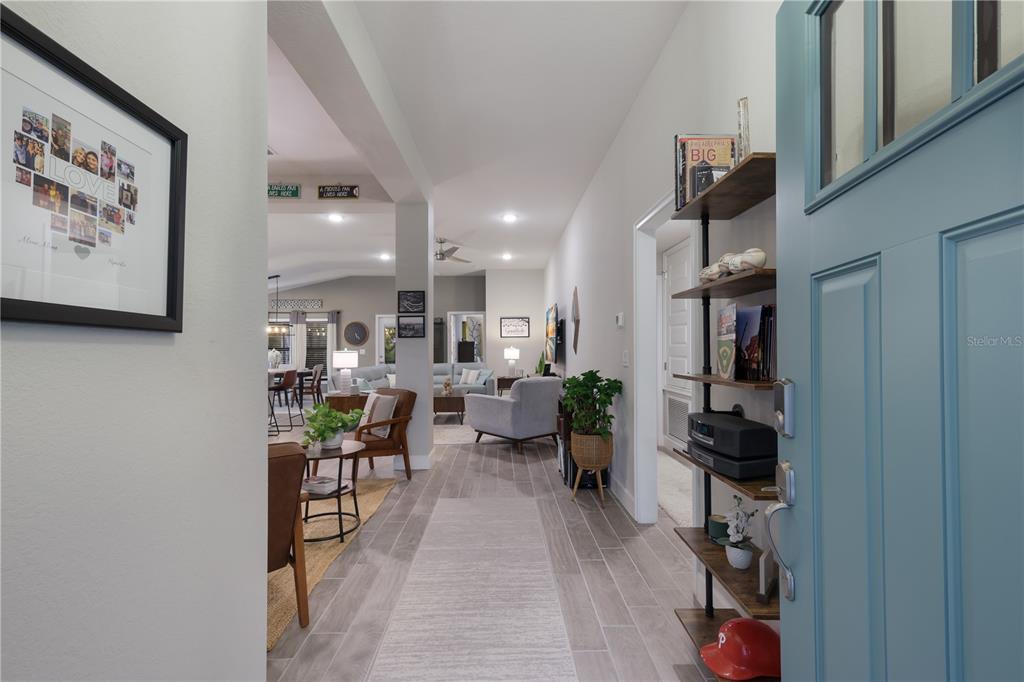 9318 46th Court East Parrish, FL 34219 - Photo 4 of 35 a living room with furniture a rug and white walls