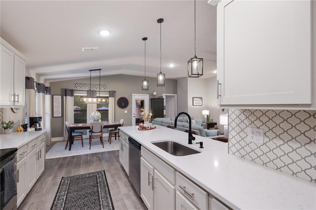 9318 46th Court East Parrish, FL 34219 - Photo 9 of 35 a kitchen with sink cabinets and wooden floor