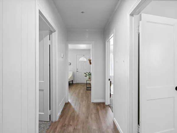 a view of a room with wooden floor
