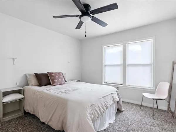 a bedroom with a bed a window and a couch