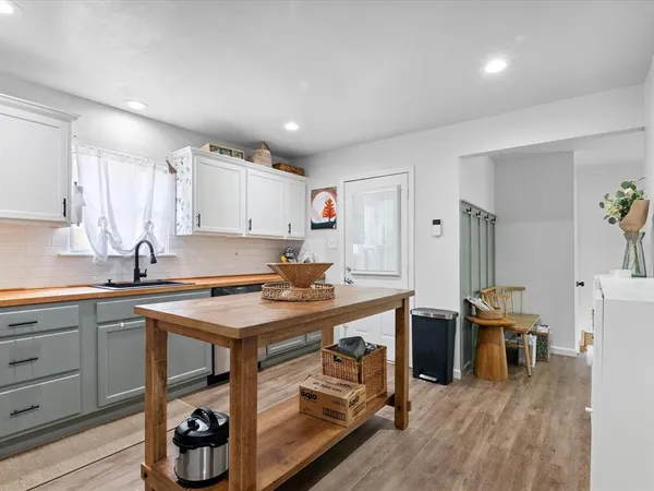 a kitchen with stainless steel appliances granite countertop a stove and a sink