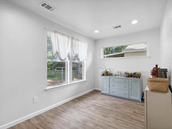 a kitchen with granite countertop a stove and a wooden floors
