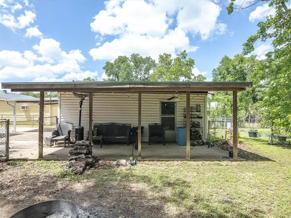 a backyard of a house with table and chairs