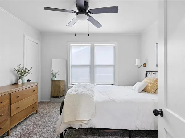 a bedroom with a bed and a window