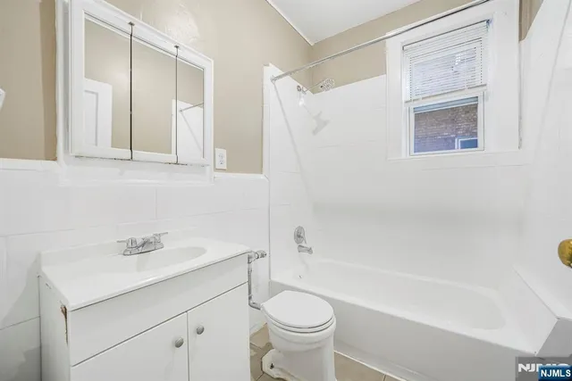 a bathroom with a sink a toilet and a bathtub
