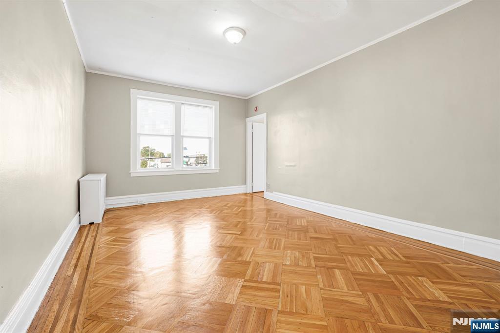 2 Washburn Place, Unit 202 Caldwell, NJ 07006 - Photo 5 of 16 wooden floor in an empty room with a window