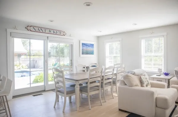 a dining room with furniture and large windows