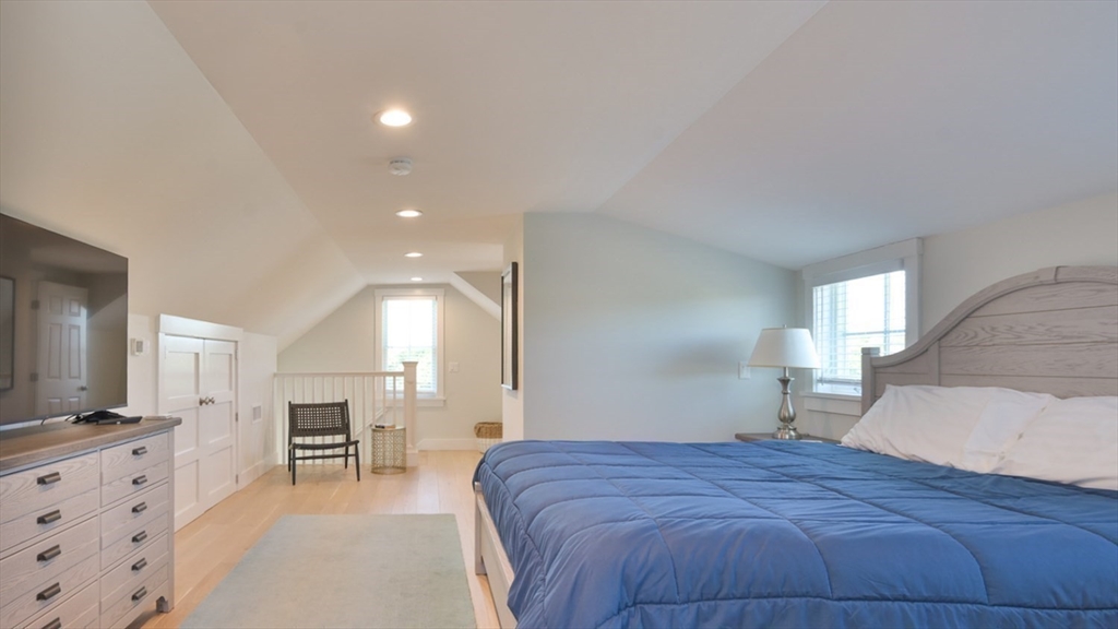 11 Miller Lane Nantucket, MA 02554 - Photo 7 of 21 a spacious bedroom with a bed and a flat screen tv