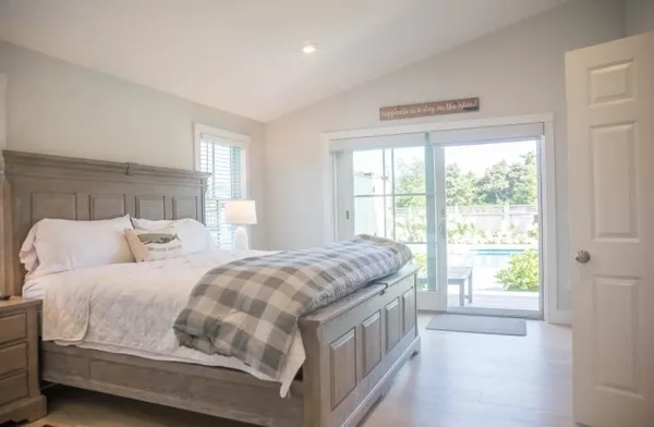 a bedroom with a bed next to a window