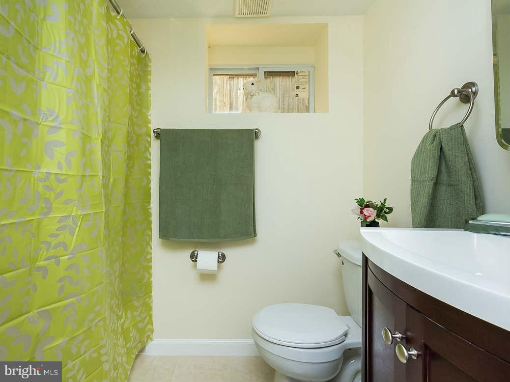 5006 Levindale Road Baltimore, MD 21215 - Photo 22 of 23 a bathroom with a sink a toilet and shower