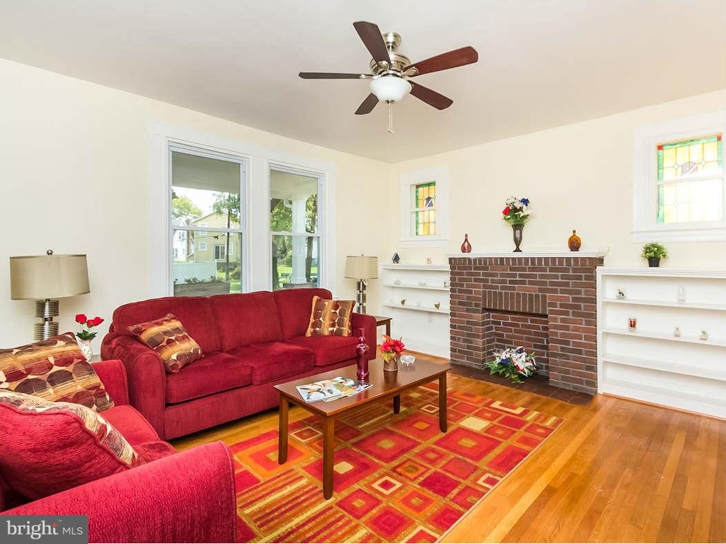 5006 Levindale Road Baltimore, MD 21215 - Photo 6 of 23 a living room with furniture and a fireplace