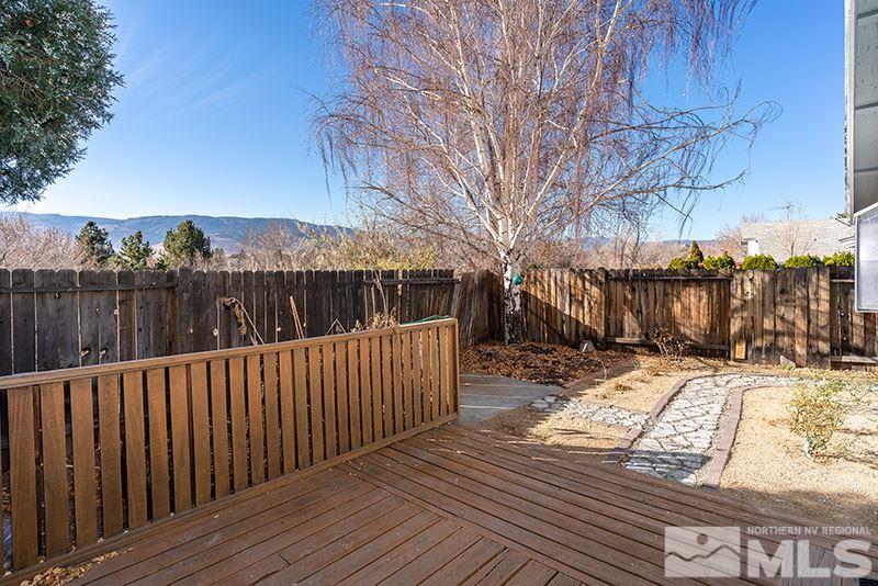 6082 Bankside Way Reno, NV 89523 - Photo 16 of 17 a view of deck with wooden fence and trees