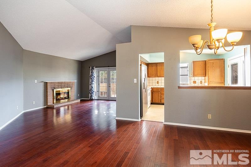6082 Bankside Way Reno, NV 89523 - Photo 4 of 17 a view of an empty room with wooden floor and a window