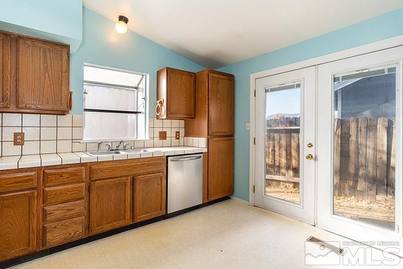 6082 Bankside Way Reno, NV 89523 - Photo 7 of 17 a kitchen with granite countertop a refrigerator sink and cabinets