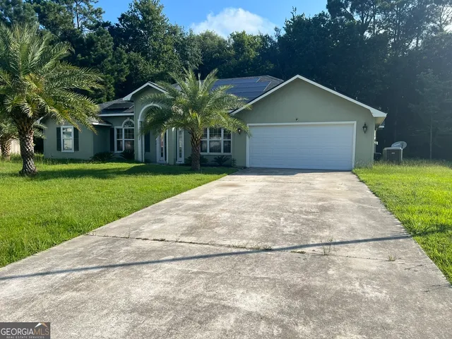 a front view of house with yard and green space