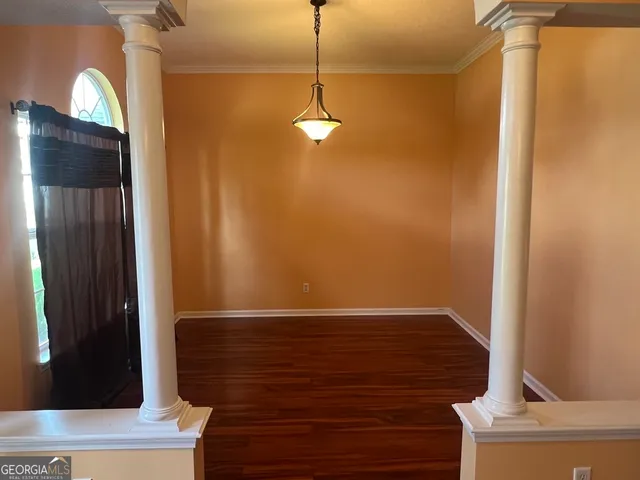a view of a room with wooden floor and cabinet
