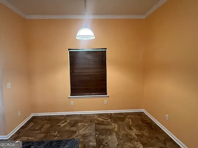 a view of an empty room and a window