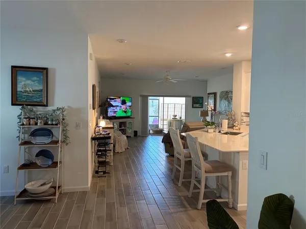 a view of a dining room with furniture wooden floor and chandelier