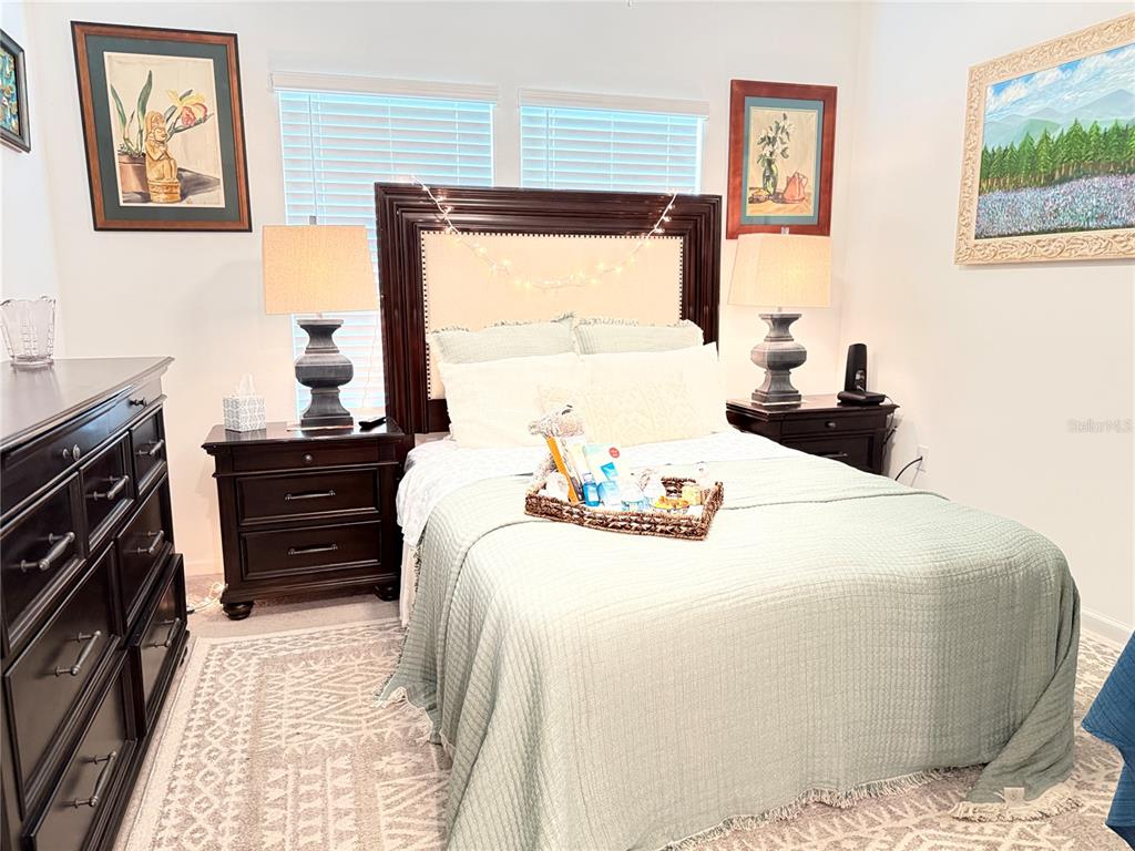 7656 Southwest 74th Loop Ocala, FL 34474 - Photo 14 of 95 a bedroom with a bed and a dresser