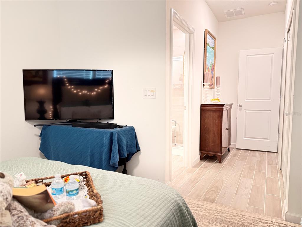 7656 Southwest 74th Loop Ocala, FL 34474 - Photo 15 of 95 a bedroom with a bed and a flat screen tv