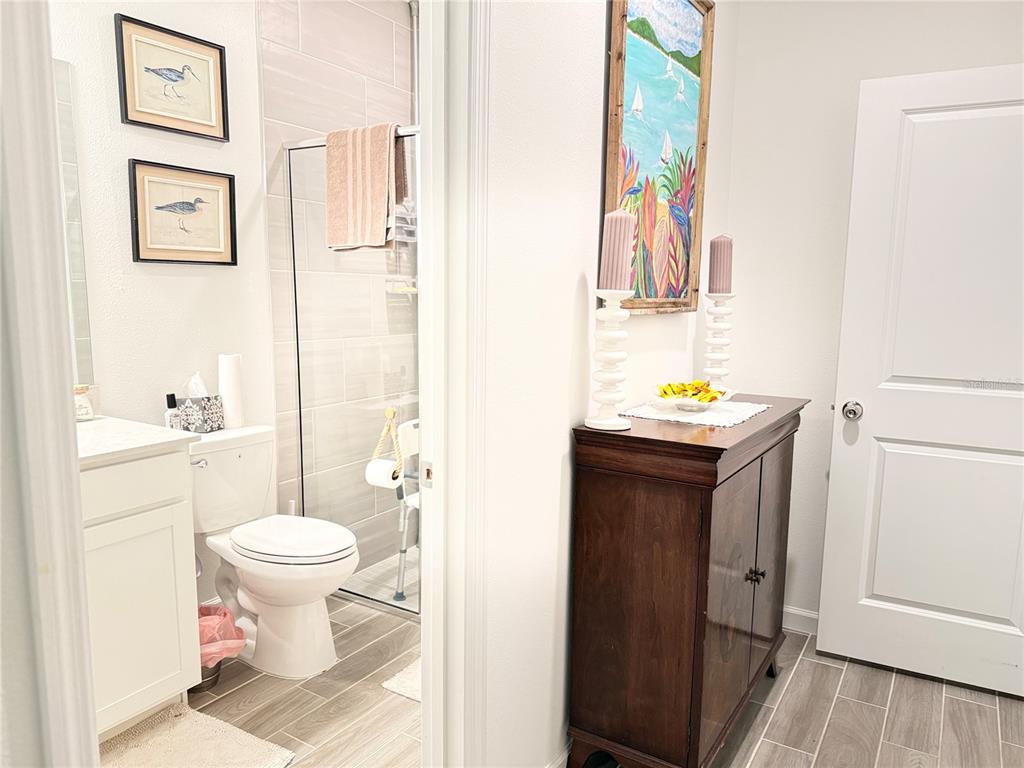 7656 Southwest 74th Loop Ocala, FL 34474 - Photo 16 of 95 a bathroom with a sink toilet and vanity