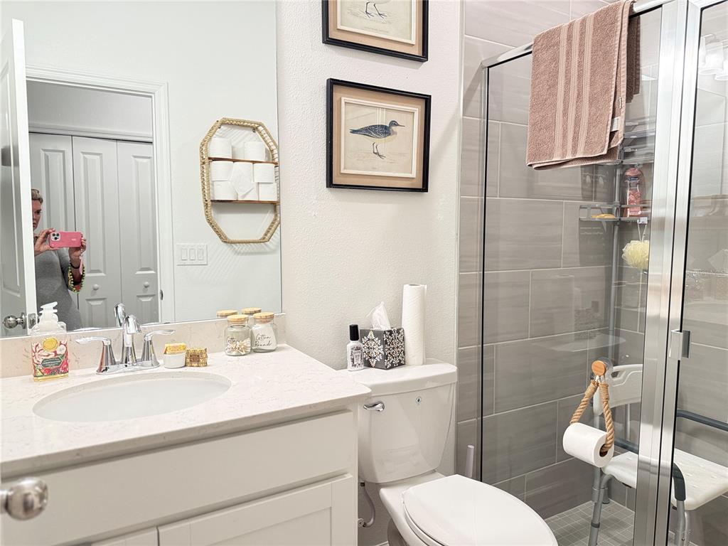 7656 Southwest 74th Loop Ocala, FL 34474 - Photo 17 of 95 a bathroom with a sink mirror vanity and toilet
