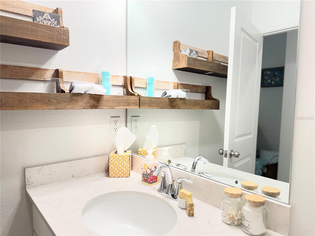 7656 Southwest 74th Loop Ocala, FL 34474 - Photo 20 of 95 a bathroom with a sink and a mirror
