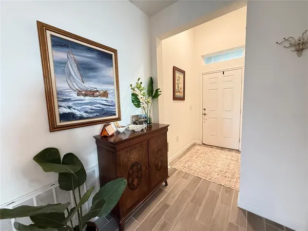 a living room with furniture and a painting on the wall