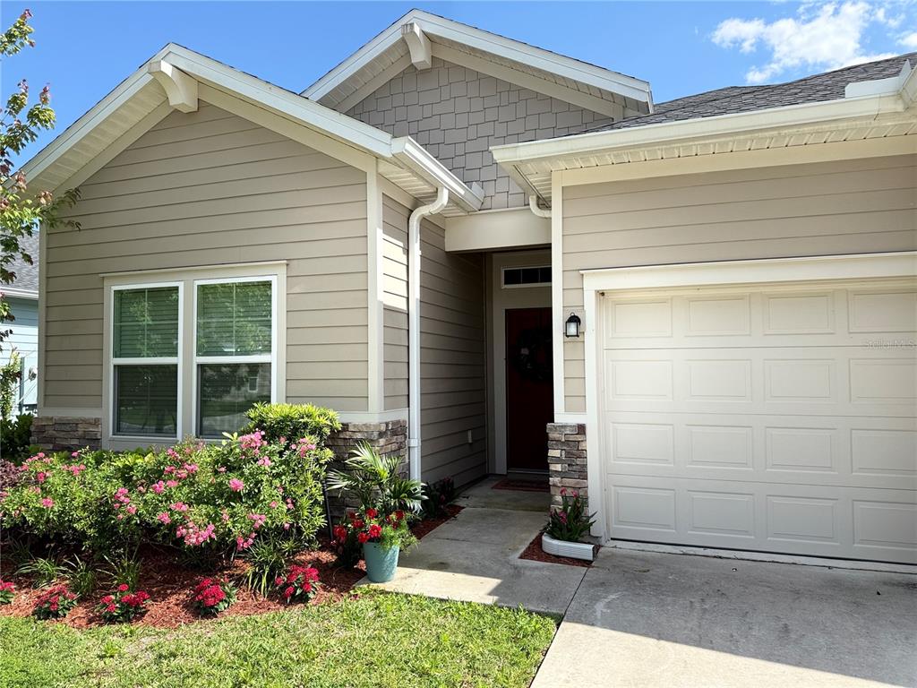 7656 Southwest 74th Loop Ocala, FL 34474 - Photo 3 of 95 a front view of a house with a yard