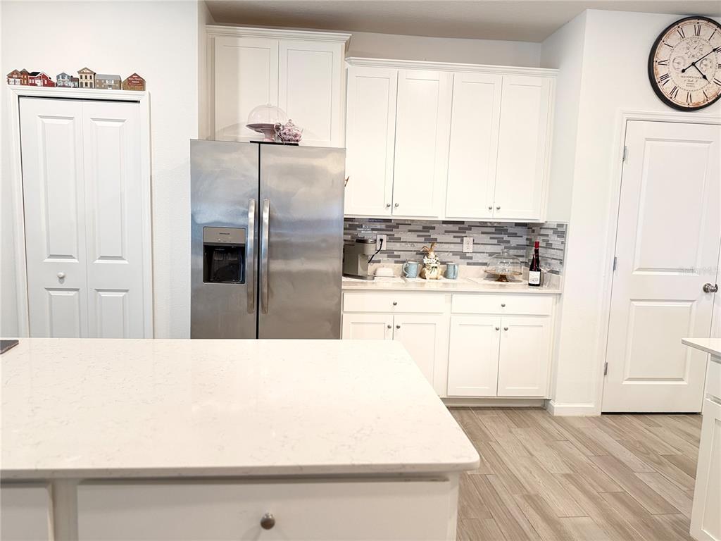 7656 Southwest 74th Loop Ocala, FL 34474 - Photo 31 of 95 a kitchen with a refrigerator sink and cabinets