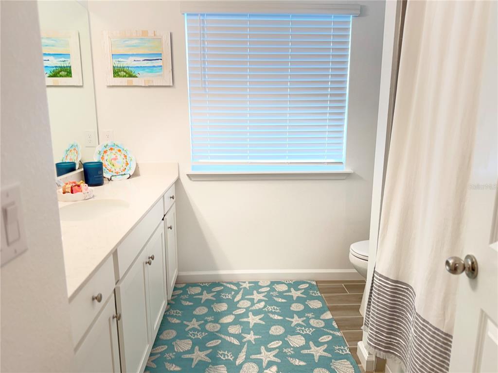 7656 Southwest 74th Loop Ocala, FL 34474 - Photo 48 of 95 a bathroom with a sink a toilet and a window
