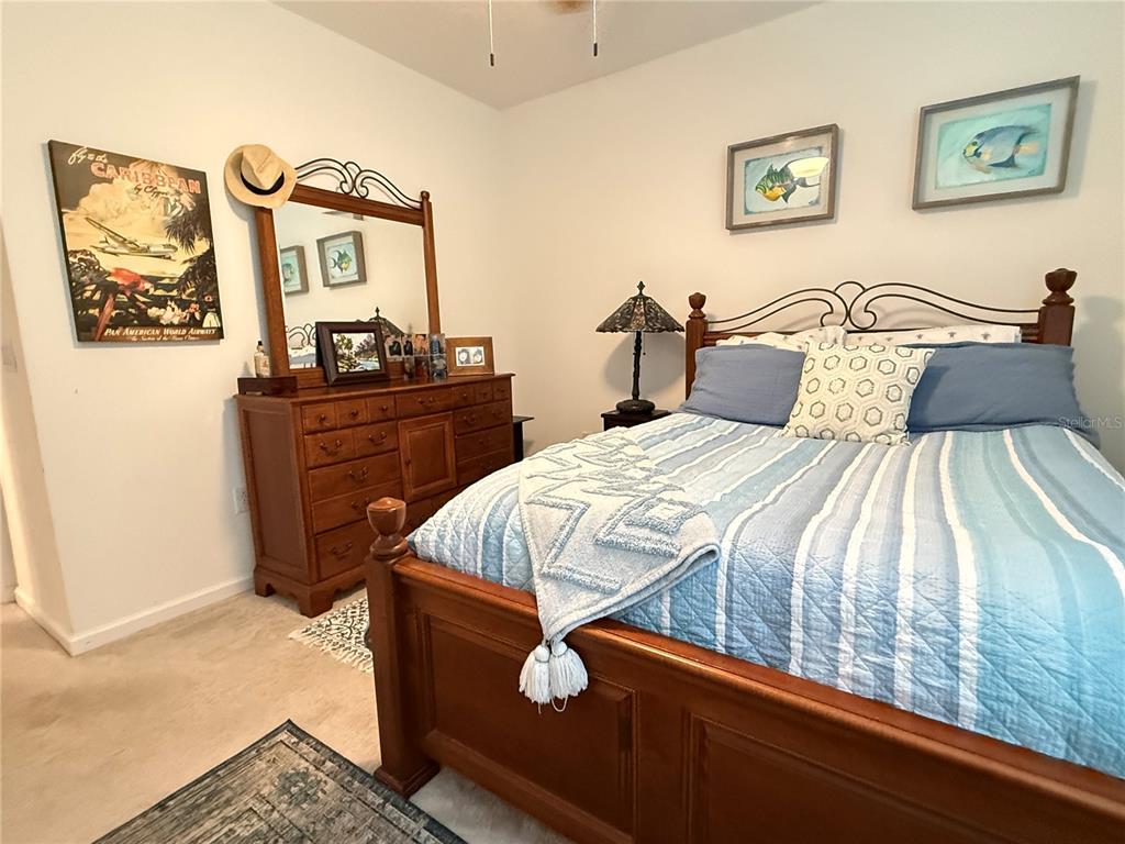 7656 Southwest 74th Loop Ocala, FL 34474 - Photo 54 of 95 a bedroom with a bed and a dresser