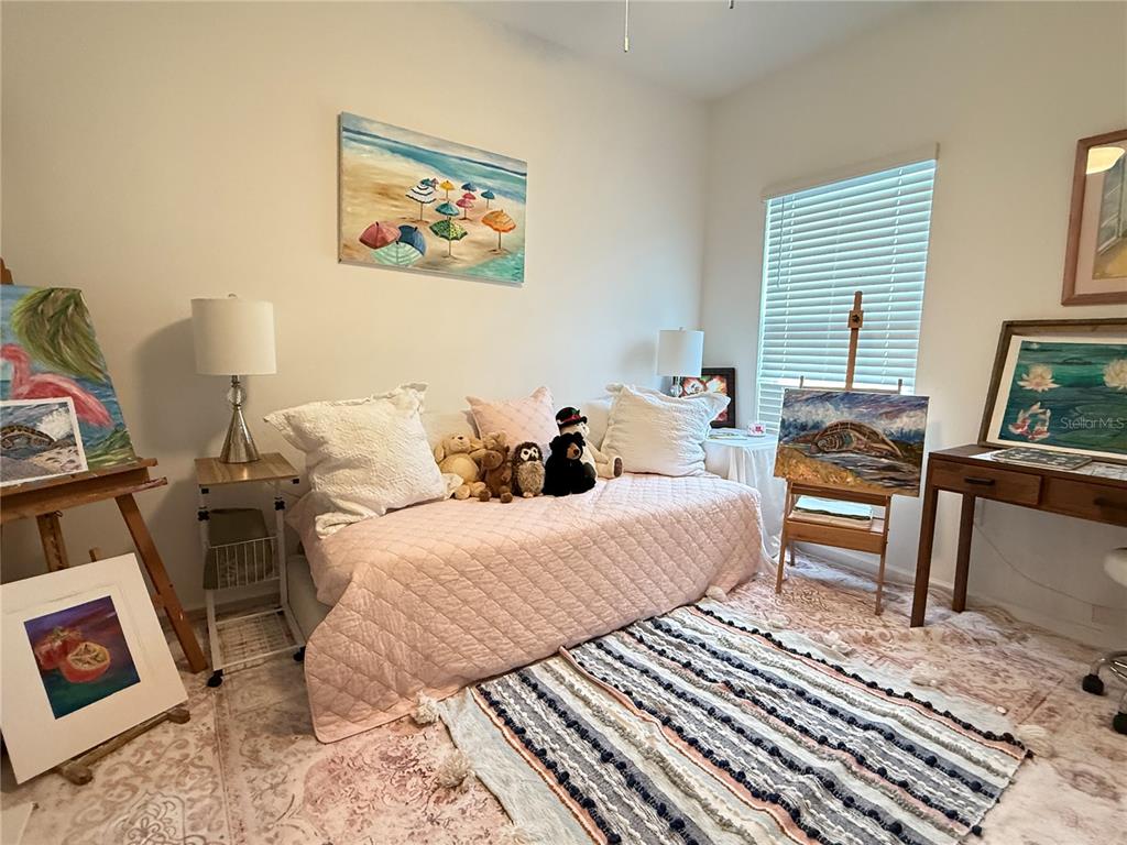 7656 Southwest 74th Loop Ocala, FL 34474 - Photo 56 of 95 a bedroom with a bed and wooden floor