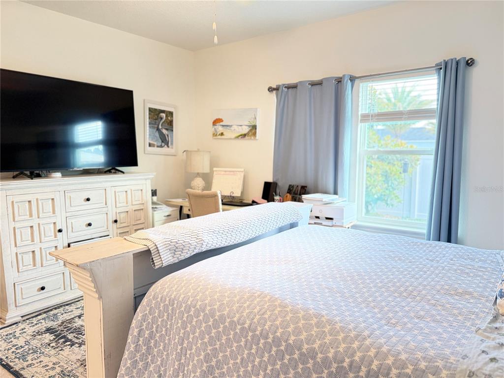 7656 Southwest 74th Loop Ocala, FL 34474 - Photo 63 of 95 a bedroom with a bed and a flat screen tv
