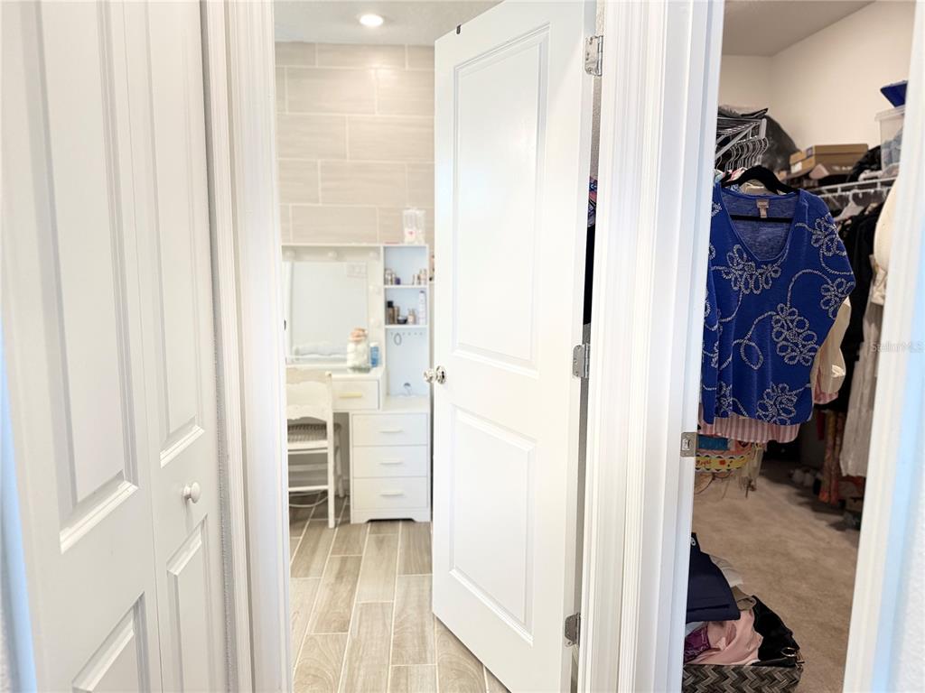 7656 Southwest 74th Loop Ocala, FL 34474 - Photo 67 of 95 a view of walk in closet with clothes and shoes