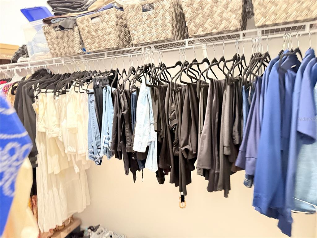 7656 Southwest 74th Loop Ocala, FL 34474 - Photo 68 of 95 a view of walk in closet with clothes and shoes