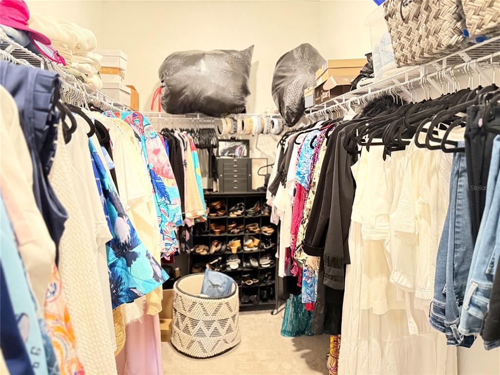 7656 Southwest 74th Loop Ocala, FL 34474 - Photo 69 of 95 a view of walk in closet with clothes and shoes