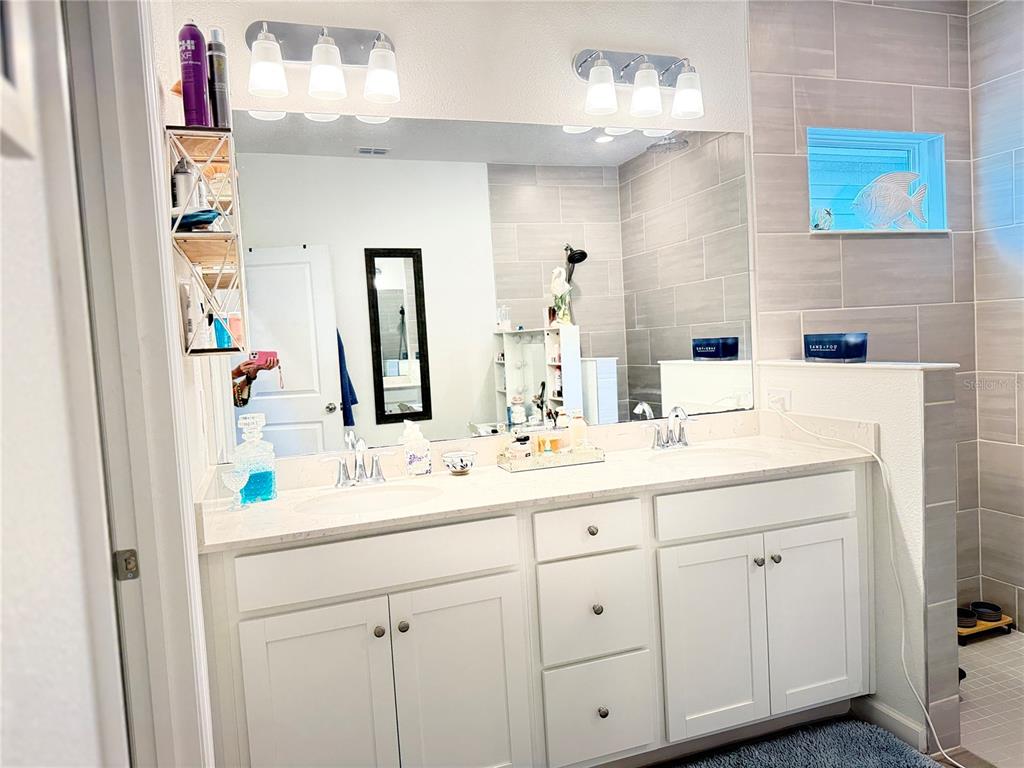7656 Southwest 74th Loop Ocala, FL 34474 - Photo 70 of 95 a bathroom with a sink and a mirror