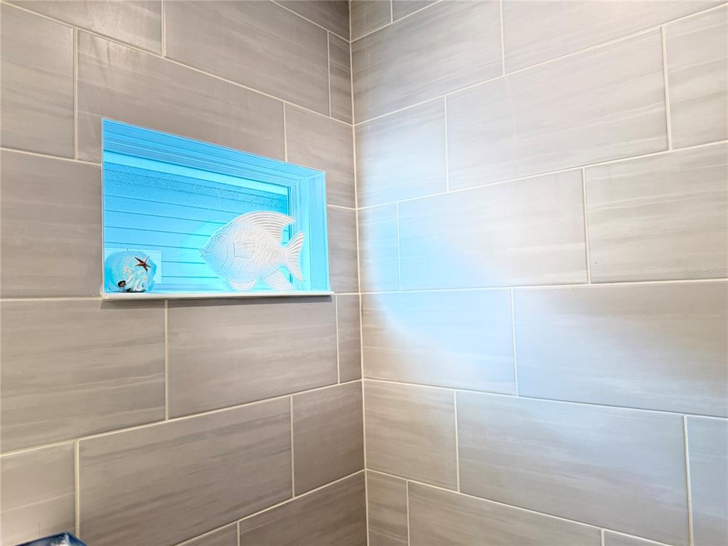 7656 Southwest 74th Loop Ocala, FL 34474 - Photo 72 of 95 a bathroom with a window and a shower