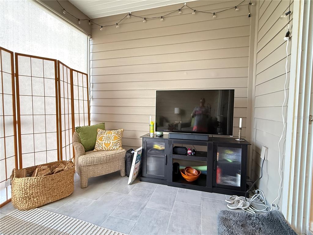 7656 Southwest 74th Loop Ocala, FL 34474 - Photo 80 of 95 a living room with furniture and a flat screen tv