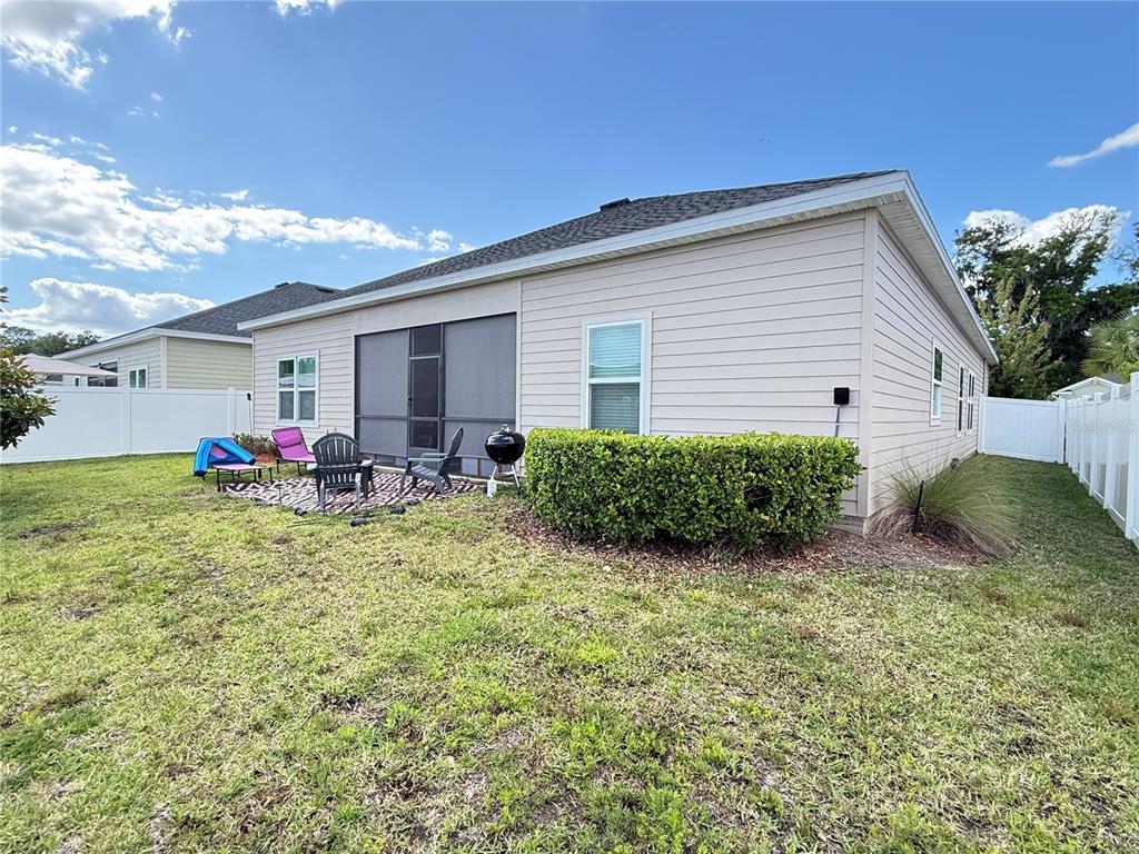 7656 Southwest 74th Loop Ocala, FL 34474 - Photo 81 of 95 a backyard of a house with table and chairs