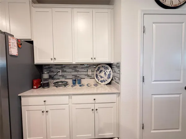 a view of a storage and utility room with countertop cabinets