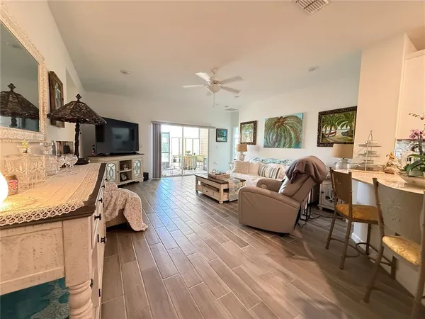 a living room with fireplace furniture and a wooden floor